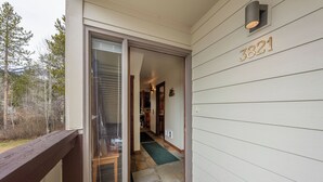 A house entrance with a sliding glass door, a wooden deck, and a mailbox with the number 3821. - Fresh interior, excellent location in Aspens (Wilson)