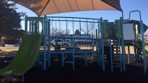 A playground with a slide, climbing structures, and a shaded area. - 50% to Book Home - Super Clean 3BR- Sleeps 6- By TNT (Page)