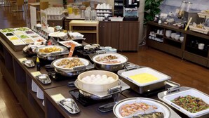 A buffet with various food items and dishes.