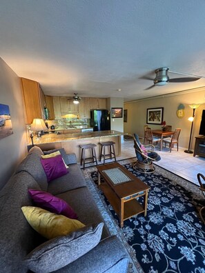 Relax in this inviting space with a comfortable sofa, dining area, and fully equipped kitchen.
