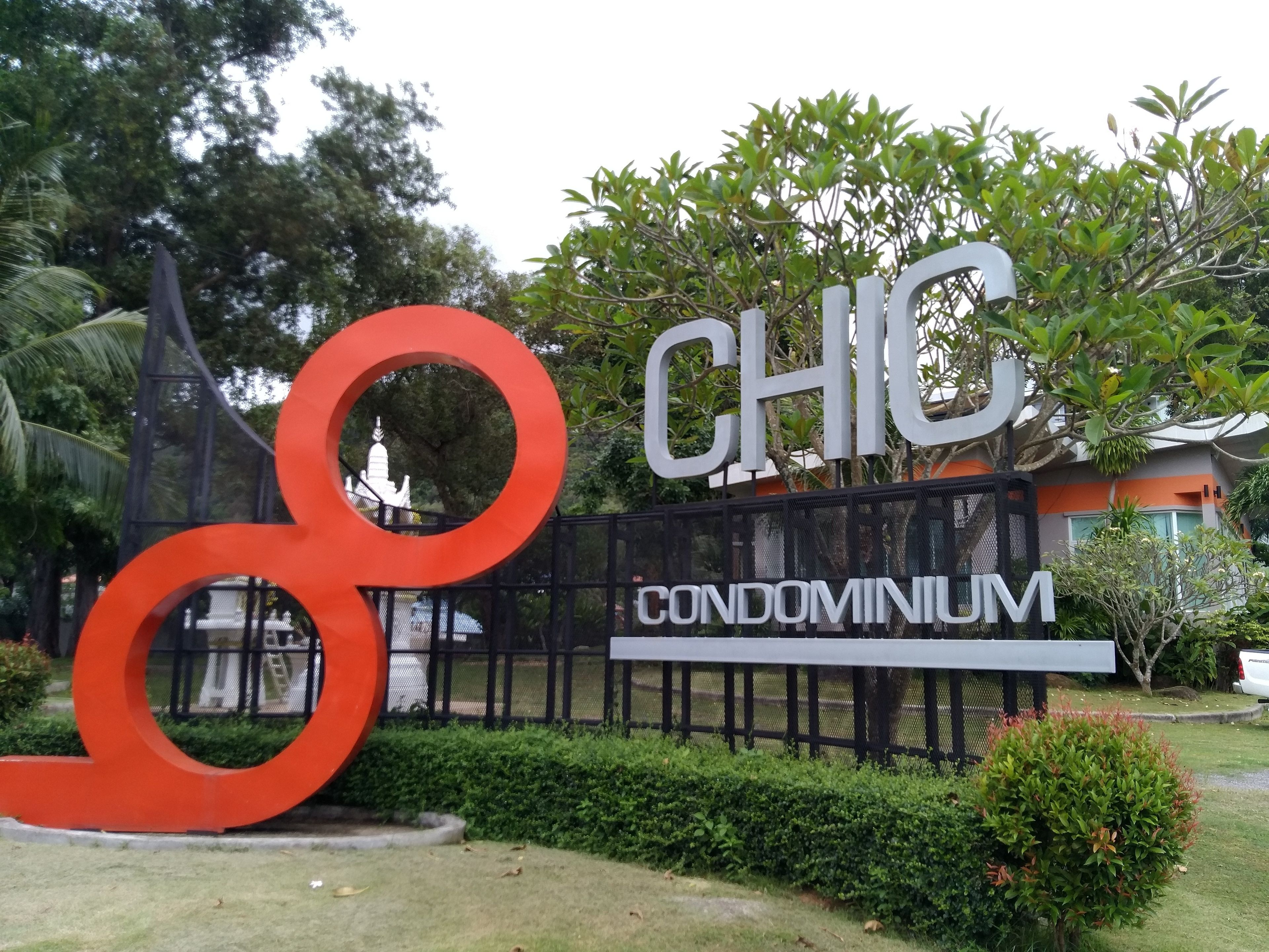 A sign for a condominium named "CHIC" with a large red '8' logo.