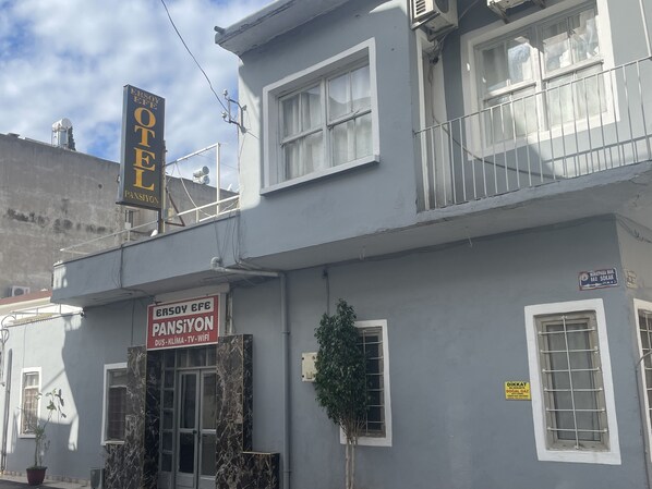 Un bâtiment portant une enseigne indiquant « ERSoy GEF PANSYON » et « ERSoy GEF OTEL ».