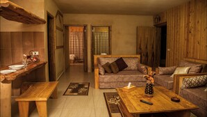 A cozy living room with a wooden bench, a sofa, and a coffee table. There is a remote control on the table. - Villetta Di Faraya (Faraya)