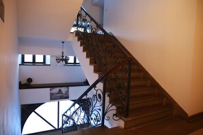 A staircase with ornate metal railings and wooden steps. - Cheltikov Hotel (Kars)