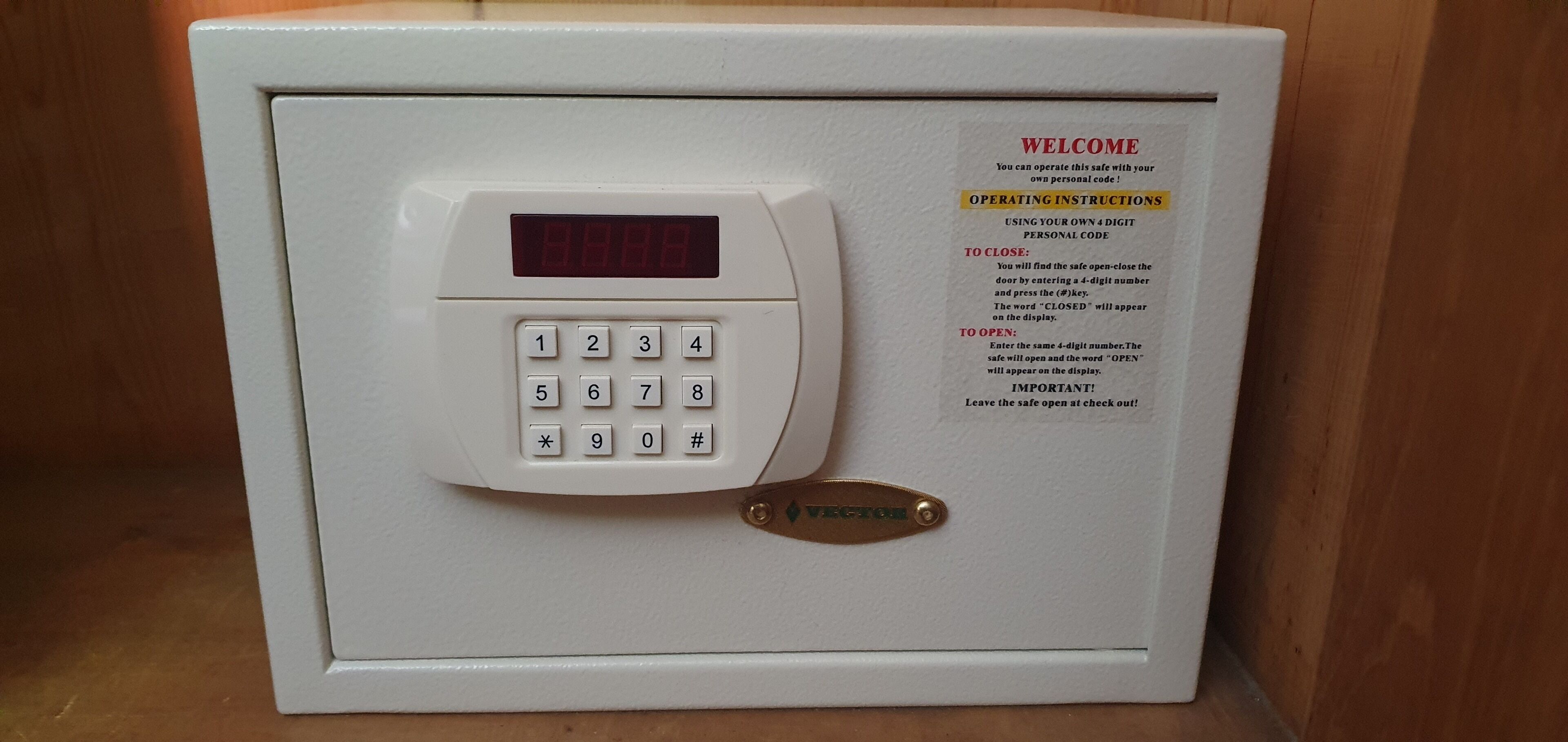 A safe with a keypad and operating instructions.