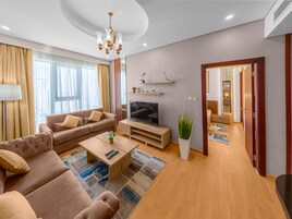 Deluxe Apartment, 1 Bedroom | Living area | 43-inch flat-screen TV with cable channels, TV