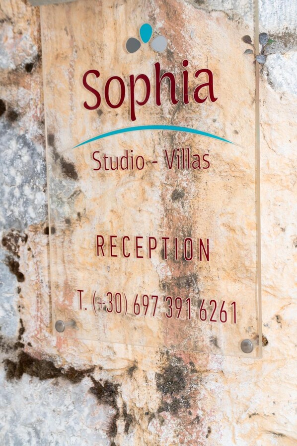 A reception sign for Sophia Studio - Villas with a contact number. - Sofia Areopoli (East Mani)