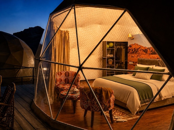 A hexagonal tent with a bed, chairs, and a wardrobe. - Hasan Zawaideh Camp (Wadi Rum)