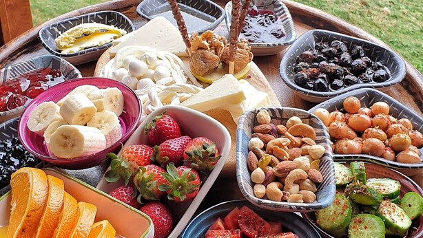 A table with various fruits and nuts. - Ayder Suit (Camlihemsin)