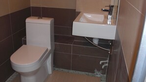 A small bathroom with a toilet and a sink. - Empire Commercial Hotel (Kowloon)
