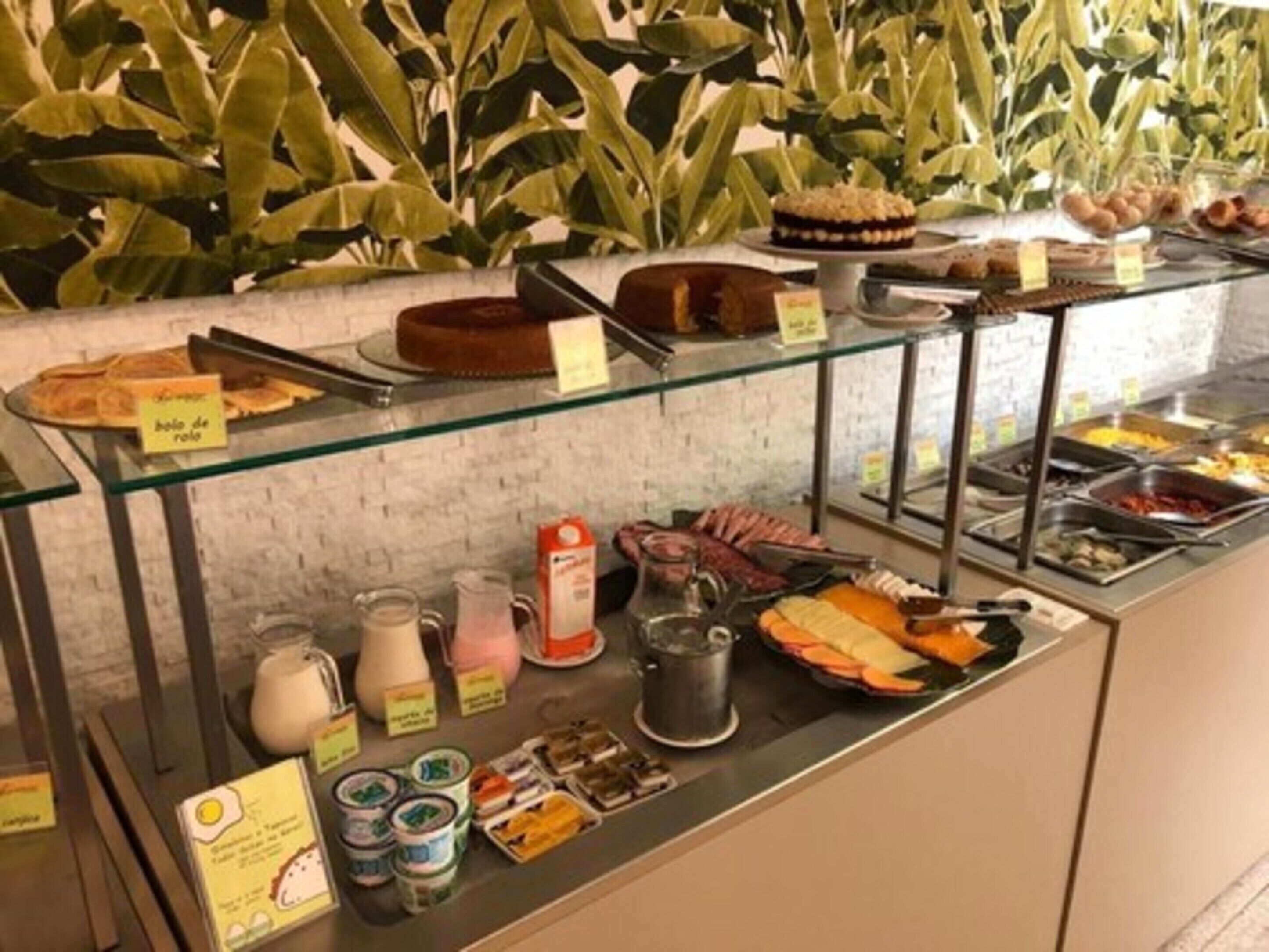 A buffet counter with various food items and condiments.