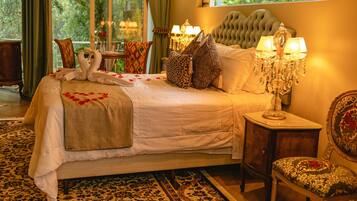 Un dormitorio elegante con una cama grande, lámparas ornamentales y vistas al exterior.