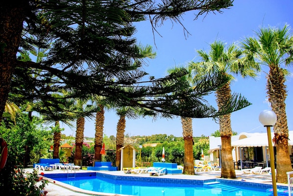 Seasonal outdoor pool, open 9:00 AM to 9:00 PM, pool umbrellas