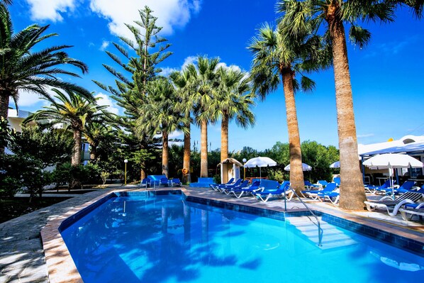 Seasonal outdoor pool, open 9:00 AM to 9:00 PM, pool umbrellas