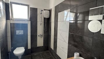 Shower, hair dryer, slippers, towels