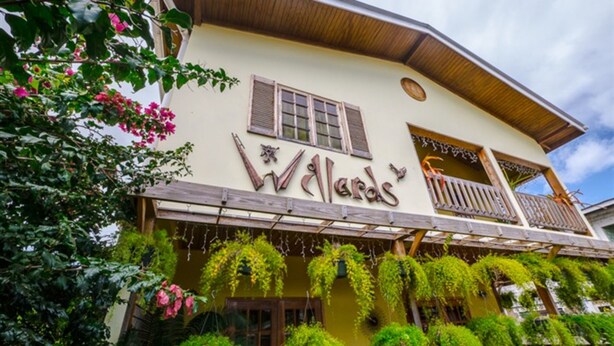 A building with the sign 'Walde's' and a balcony with wooden railings.