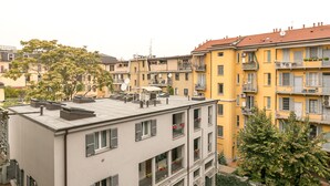 A multi-story building with balconies, satellite dishes, and potted plants. - notaMi -  Borsieri 29 (Milan)