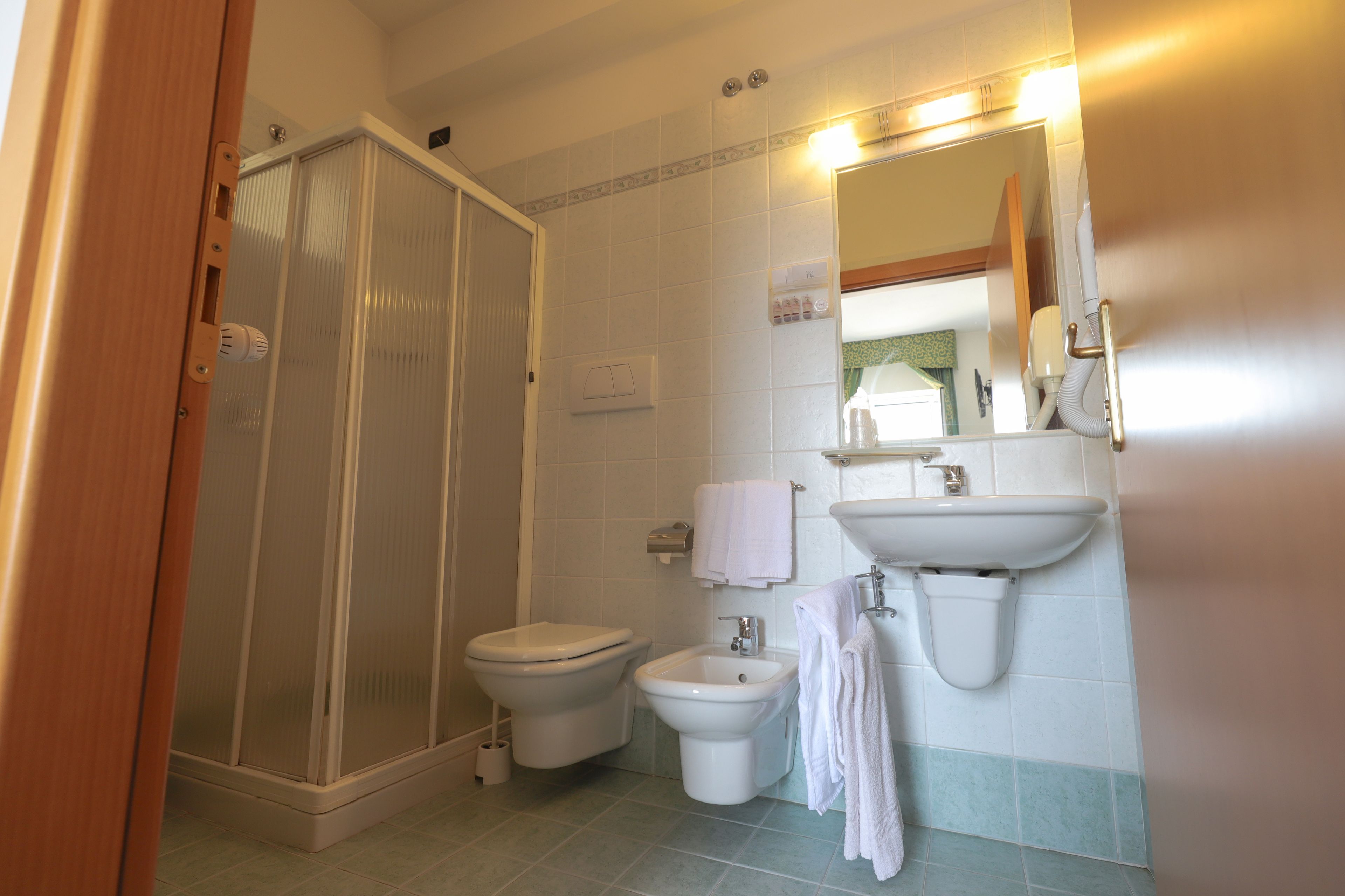 superior double room | bathroom | shower, free toiletries, hair dryer, towels
