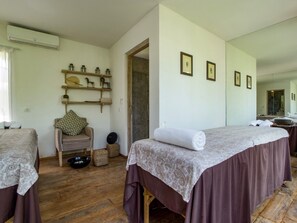 A room with two beds, a wooden floor, a shelf with decorative items, and a mirror on the wall. - Mannao Estate by Villa Finder (Kerobokan)