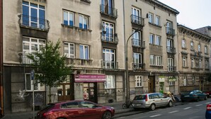 A multi-story building with a sign for a business on the ground floor. - Otium Old Town Łobzowska (Kraków)