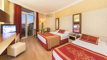 A hotel room with two beds, a TV, a desk, and a chair.