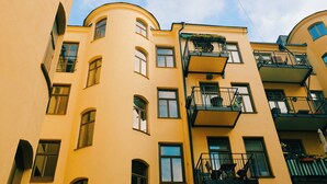 A multi-story building with balconies and windows.