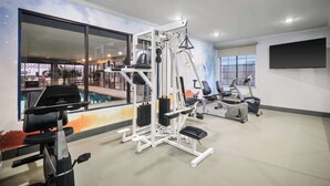 A gym with exercise equipment, large windows, and a view of the outside. - Melrose @ Seabrook, BW Signature Collection (Seabrook)