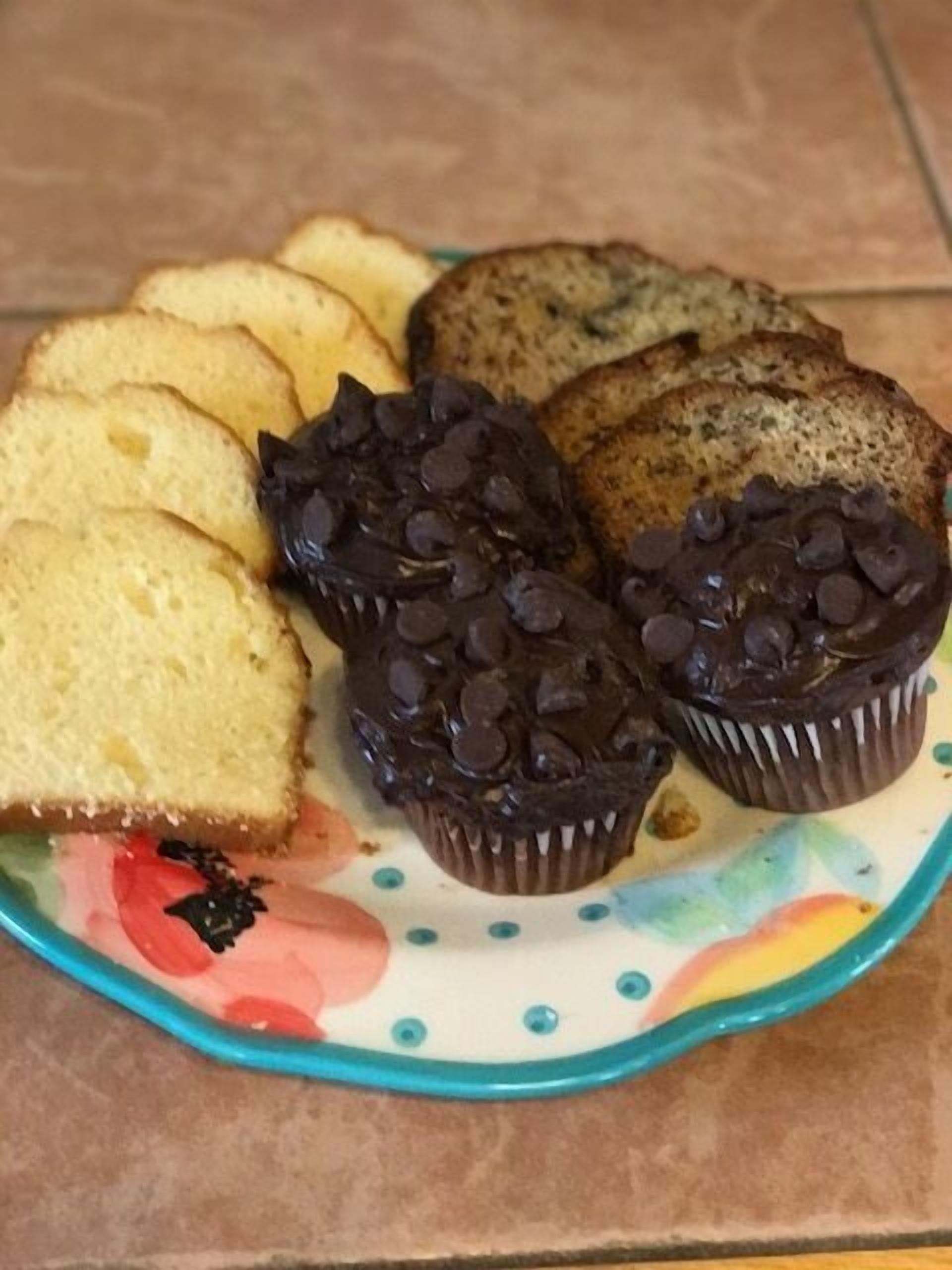 A plate with various baked goods including muffins and slices of bread.