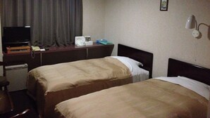 A hotel room with two beds, a desk with a television, a telephone, and a small table with a coffee maker. - Business Hotel Kamoshita (Mito)