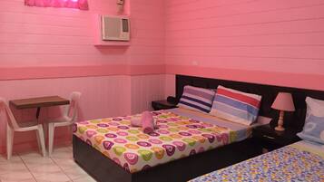 A pink-themed bedroom with a bed, a desk, and a chair.