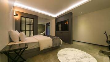 Een moderne hotelkamer met een bed, een marmeren tafel en een groot raam.