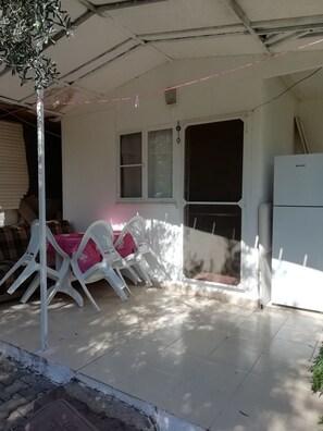 Relax on the patio with a comfortable seating area featuring a sofa, chairs, and table.