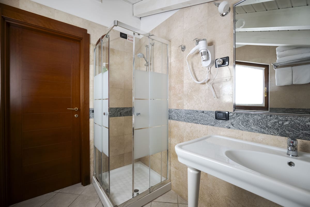 comfort quadruple room | bathroom | shower, rainfall showerhead, designer toiletries, hair dryer