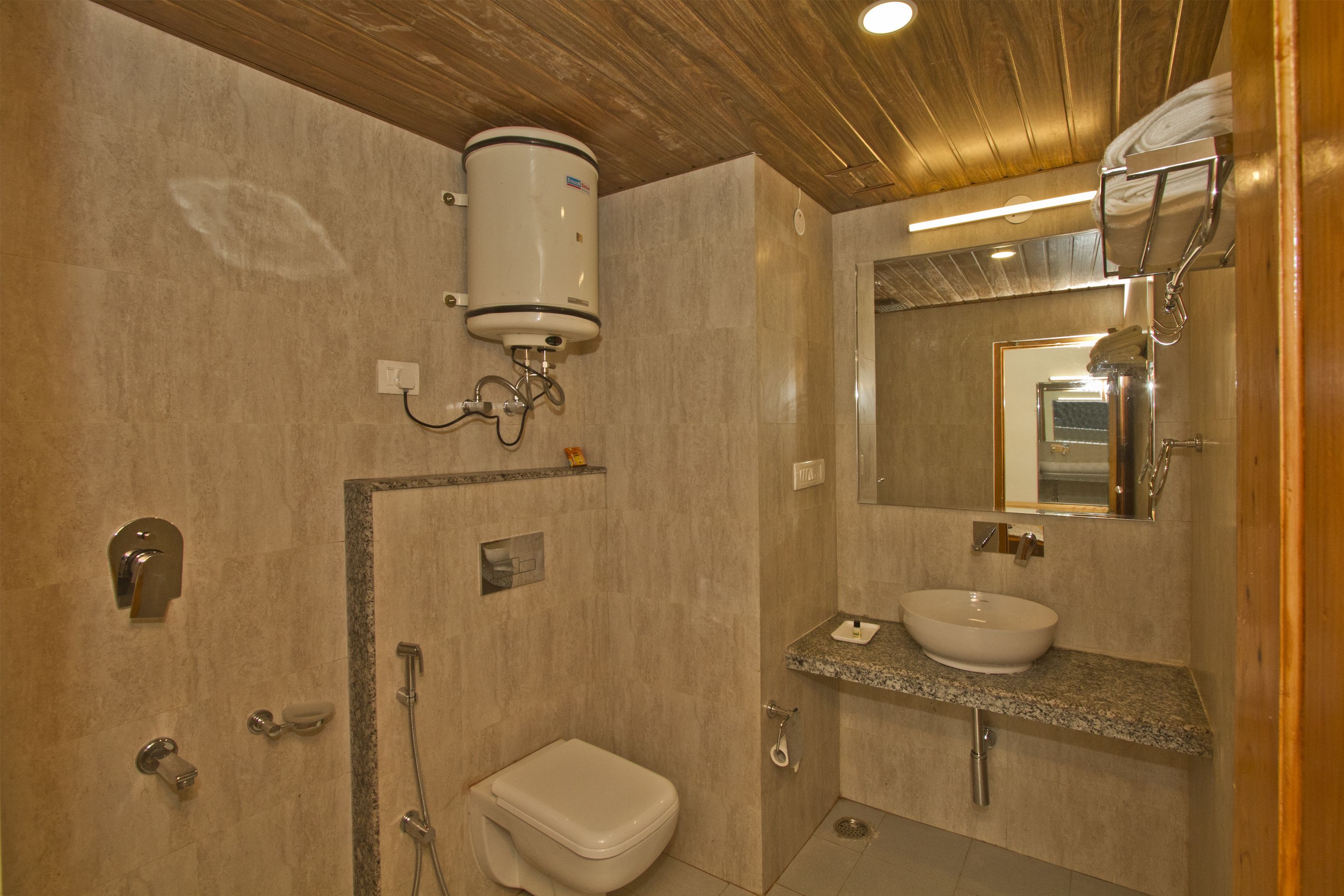 A modern bathroom with a built-in toilet, a sink, and a shower.