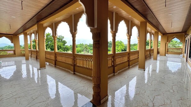 A spacious hall with a high ceiling and marble flooring, featuring ornate arches and a balcony with a view of greenery. - Pushkar Rajwara Resort (Pushkar)