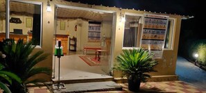 A small, well-lit building with a glass door, a bench inside, and a poster on the wall. - Pushkar Rajwara Resort (Pushkar)