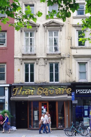A Thai Square restaurant with a classic facade, large windows, and a visible entrance. - The London Agent The Strand (London)