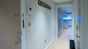 A hallway with a sign reading "SPITALFIELDS E1" and a modern kitchen in the background. - The London Agent Spitalfields (London)