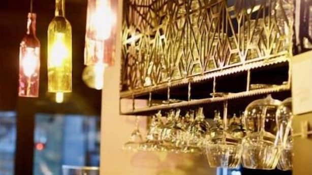 A bar area with hanging lights, a glass jar, and a decorative metal piece. - Lotus Apart Pansiyon (Koycegiz)