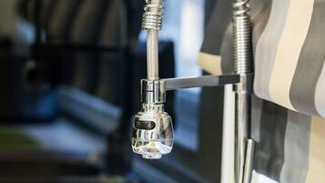 A modern kitchen with a stainless steel sink and a flexible faucet.