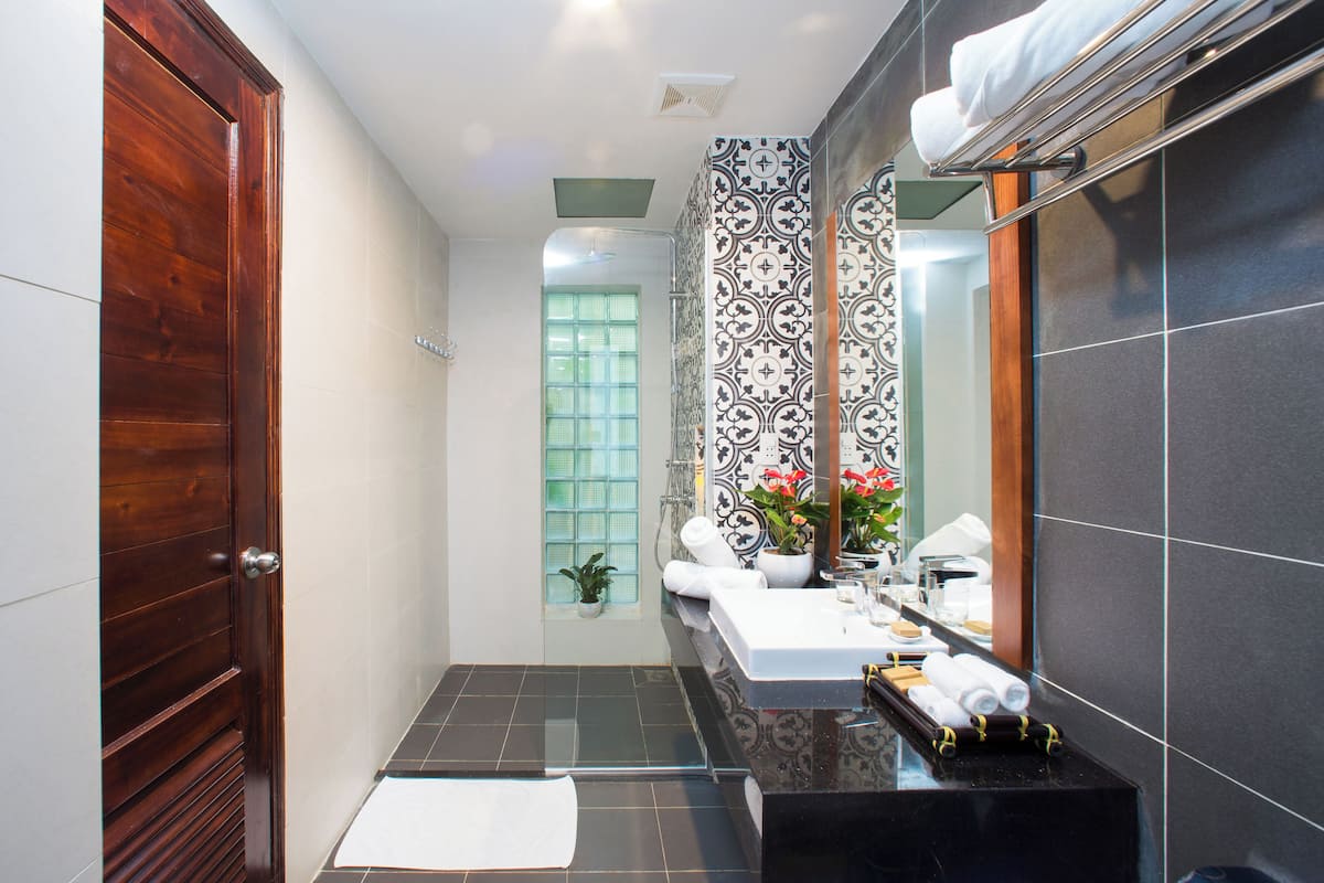 designer toiletries, hair dryer, bathrobes, slippers