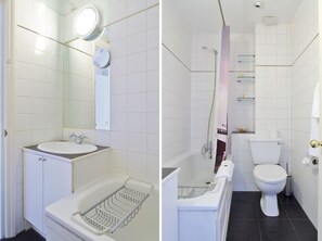 A bathroom with a sink, mirror, and shower.