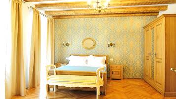 A bedroom with a wooden bed, a nightstand, a wardrobe, and a mirror on the wall.