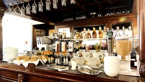 A bar area with a variety of bottles, glasses, and utensils on display.