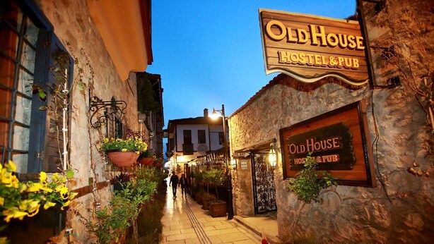 Une rue étroite où se trouve un bâtiment portant l’inscription « Old House Hostel & Pub ».