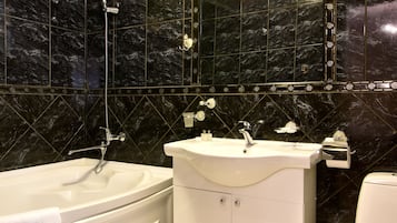 Driepersoonskamer | Badkamer | Een douche, gratis toiletartikelen, een haardroger, handdoeken