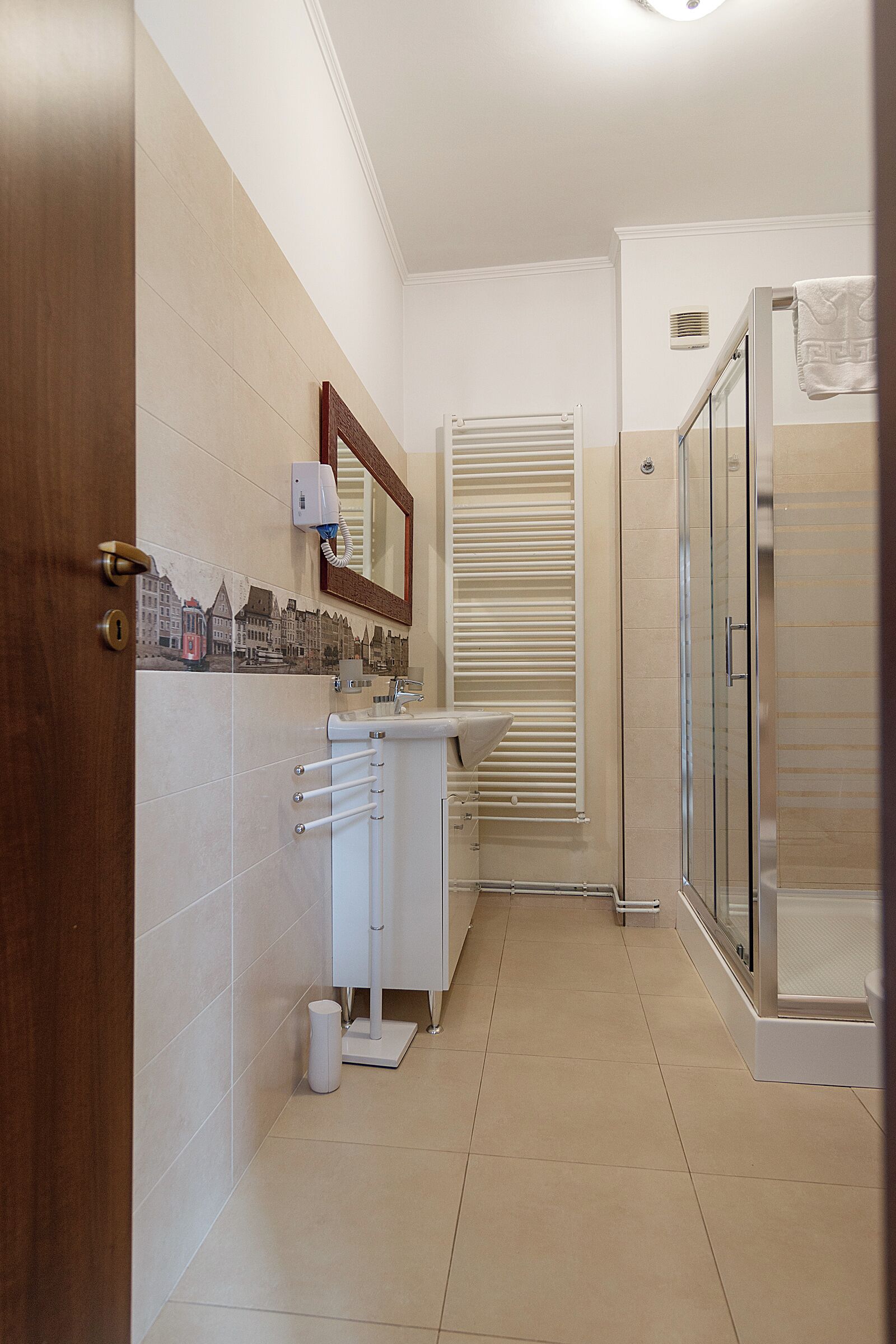 A modern bathroom with a toilet, sink, and shower.