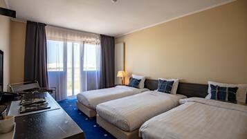 Une chambre d’hôtel avec deux lits, un bureau et une chaise.