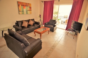 Family Apartment, 2 Bedrooms, City View, Ground Floor | Living room | Flat-screen TV - Ground level Apartment w Balcony RDS (Playa del Carmen)