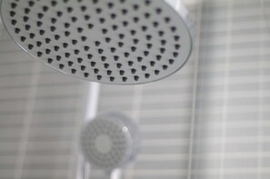 A showerhead with a circular pattern of holes. - The London Agent Fitzrovia Studio 2 (London)